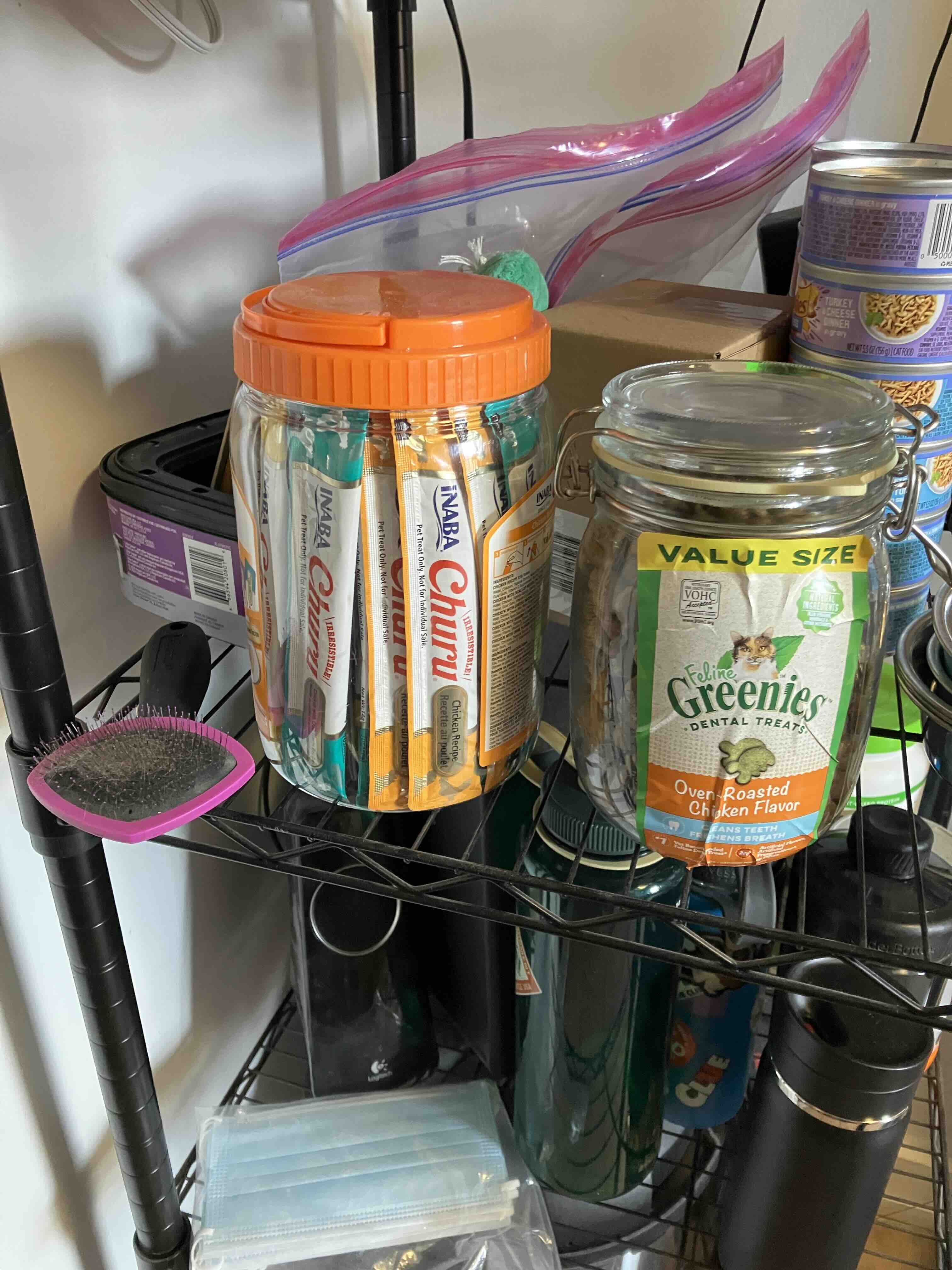 An image of cat treats on the storage rack in the kitchen.